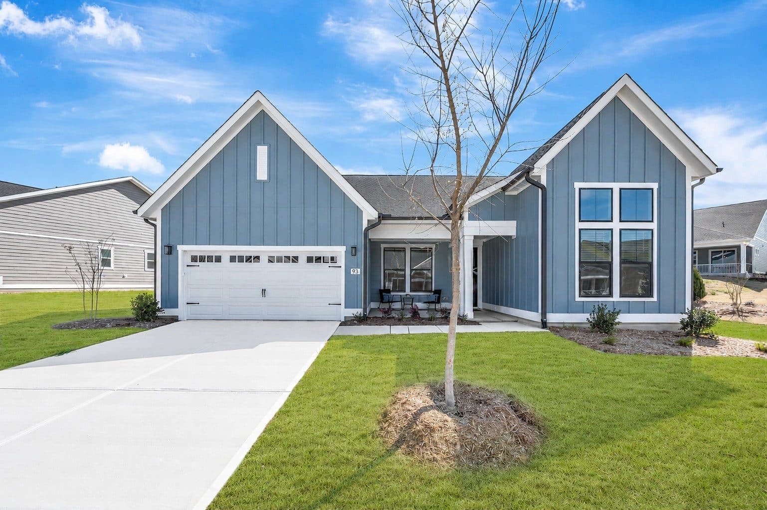 New blue model home with white trim in a fresh development